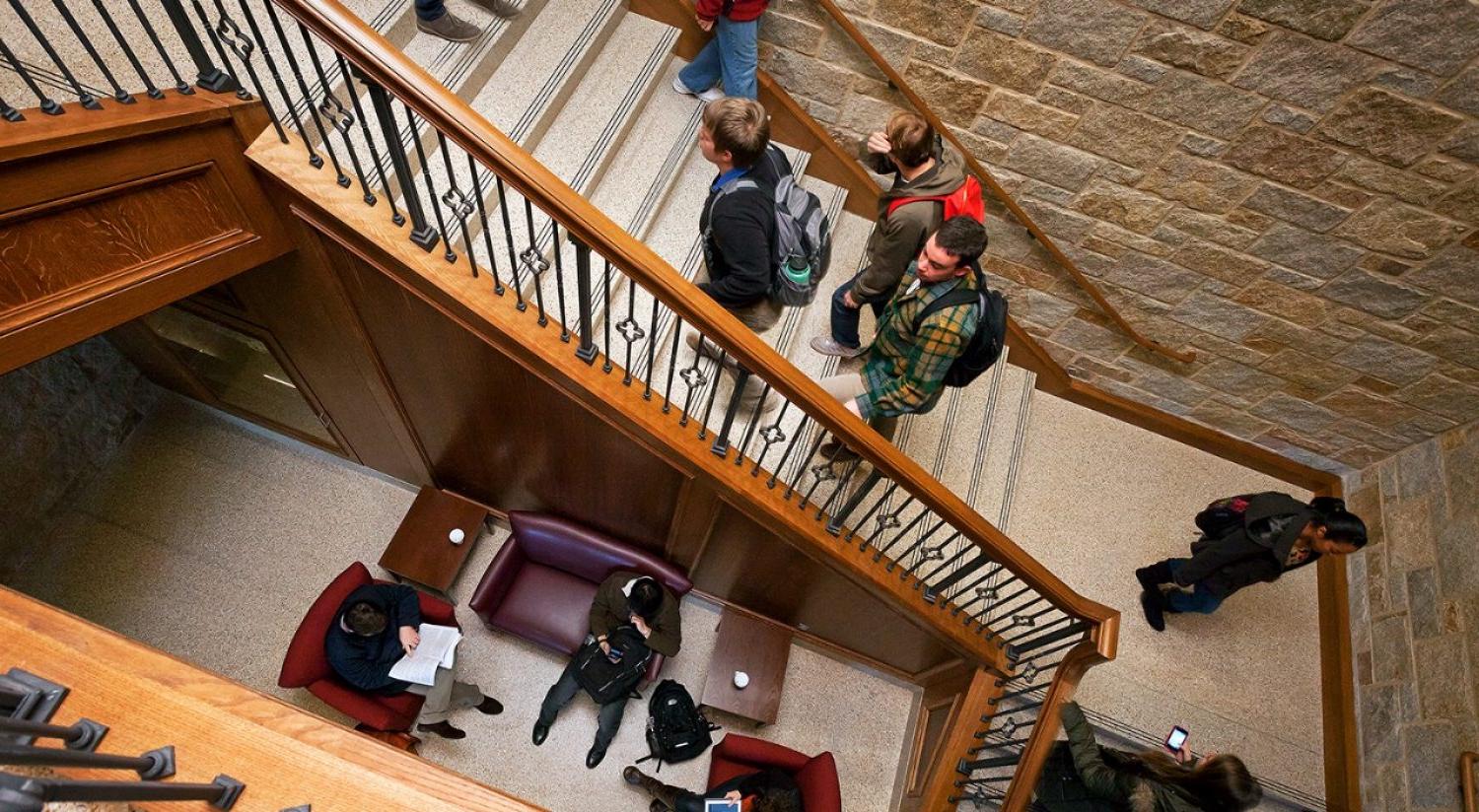 Students ascending the interior stairway in Stokes Hall